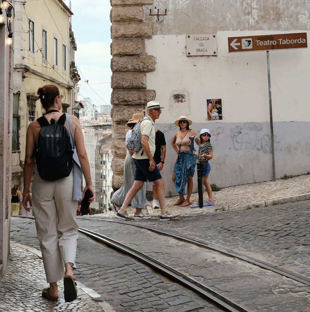 People walking through the streets of Lisbon, enjoying the city atmosphere and daily life.